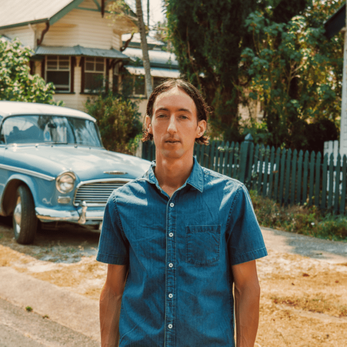 In a wonderland, a man wearing a blue shirt stands out as better than me.