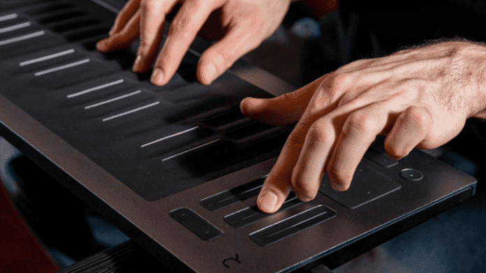 A man is playing a Seaboard RISE 2, achieving seamless integration and utilizing MPE to create expressive music with his hands.