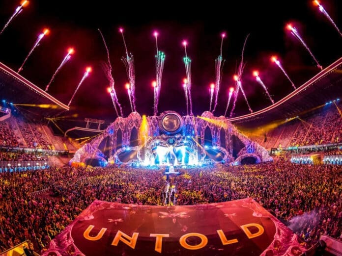 A large stage with UNTOLD Dubai fireworks in the background.