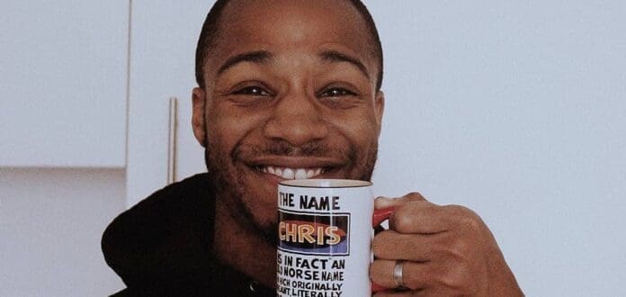 A man is holding a coffee mug with the quote 