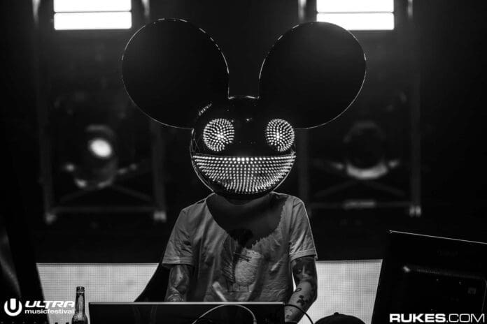 A person wearing a classic mickey mouse mask in front of a DJ playing a Jauz remix.